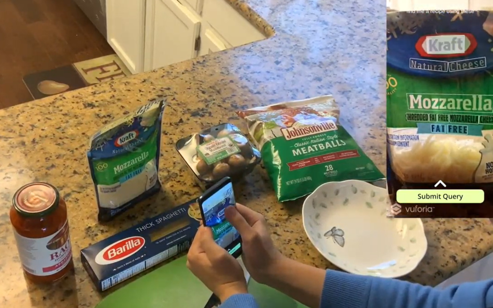 A person pointing their phone at an ingredient after asking 'find me a recipe that uses these.' TouchVA generates a touch interface, which users can tap different objects and texts to include them in their query.